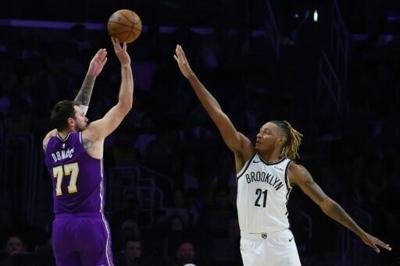 Luka Doncic of the Los Angeles Lakers shoots over Noah Clowney in the Lakers' NBA victory over the Brooklyn Nets