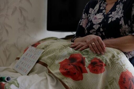 Unable to even nod his head, Kuchynsky communicates through an alphabet board