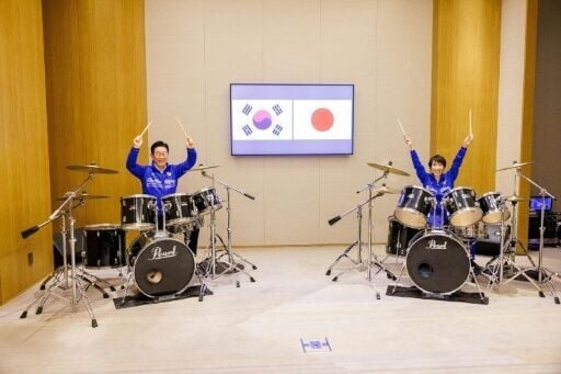 South Korea's President Lee Jae Myung (L) and Japan's Prime Minister Sanae Takaichi playing drums, in Nara, Nara Prefecture