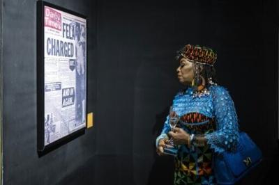 Yeni Kuti, Fela's daughter, looks at a headline on Fela Kuti at the Afrobeat Rebellion exhibition in 2025