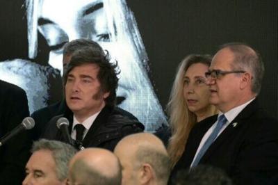 Argentina's President Javier Milei (L) speaks next to Presidency Secretary Karina Milei (2-R) and Israel ambassador to Argentina Eyal Sela (R), during a ceremony to commemorate the 34th anniversary of the 1992 bombing at the Israeli embassy in Buenos Aires