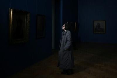 A woman visits the National Art Museum in Kyiv during the power cut that impacted lights, heating, water and transport in the war-besieged city