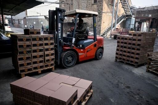 A worker transports beer crates using a forklift inside the production unit of Murree Brewery in Rawalpindi