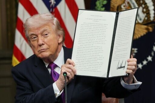 President Donald Trump holds the non-binding Ratepayer Protection Pledge, designed to shift energy costs from AI data centers away from consumers