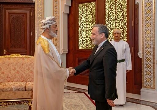 This handout photograph released by the Iran's Foreign Ministry on April 26, 2026 shows Iranian Foreign Minister Abbas Araghchi (R) shaking hands with the Sultan of Oman, Haitham bin Tariq before their meeting in Muscat