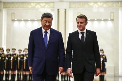 China's President Xi Jinping and France's President Emmanuel Macron attend a welcome ceremony at the Great Hall of the People in Beijing on December 4, 2025
