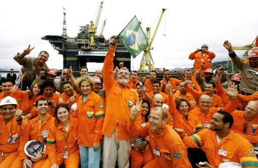 Left-wing president Luiz Inacio Lula da Silva (C) waved a national flag next to his wife Marisa Leticia, enthusiastically backing another oil project from state-owned Petrobras in 2008