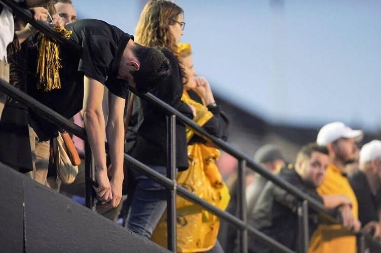 A Missouri fan slumps over the rail (copy)