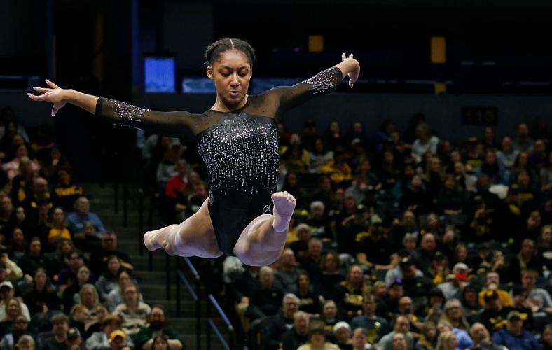 Railey Jackson performs a split leap during her beam routine