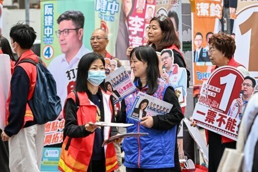 Supporters campaign for their candidates in the Legislative Council elections in Hong Kong's Wanchai district