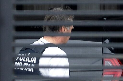 Former Brazilian President Jair Bolsonaro arrives at his house after being discharged from the hosptial in this photo released by Metropoles. He will continue to serve his 27-year sentence for attempted coup from home