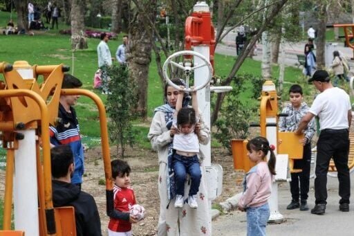 Children play on workout equipment at Tehran's Melat park during 'Sizdeh Bedar' (Nature Day), the 13th day after the Nowruz Persian New Year