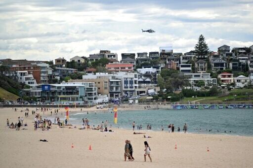 A police helicopter patrols over the Bondi Beach as life gradually returns to normal following seven days of mourning, a week after the Bondi Beach shooting attack, in Sydney on December 22, 2025