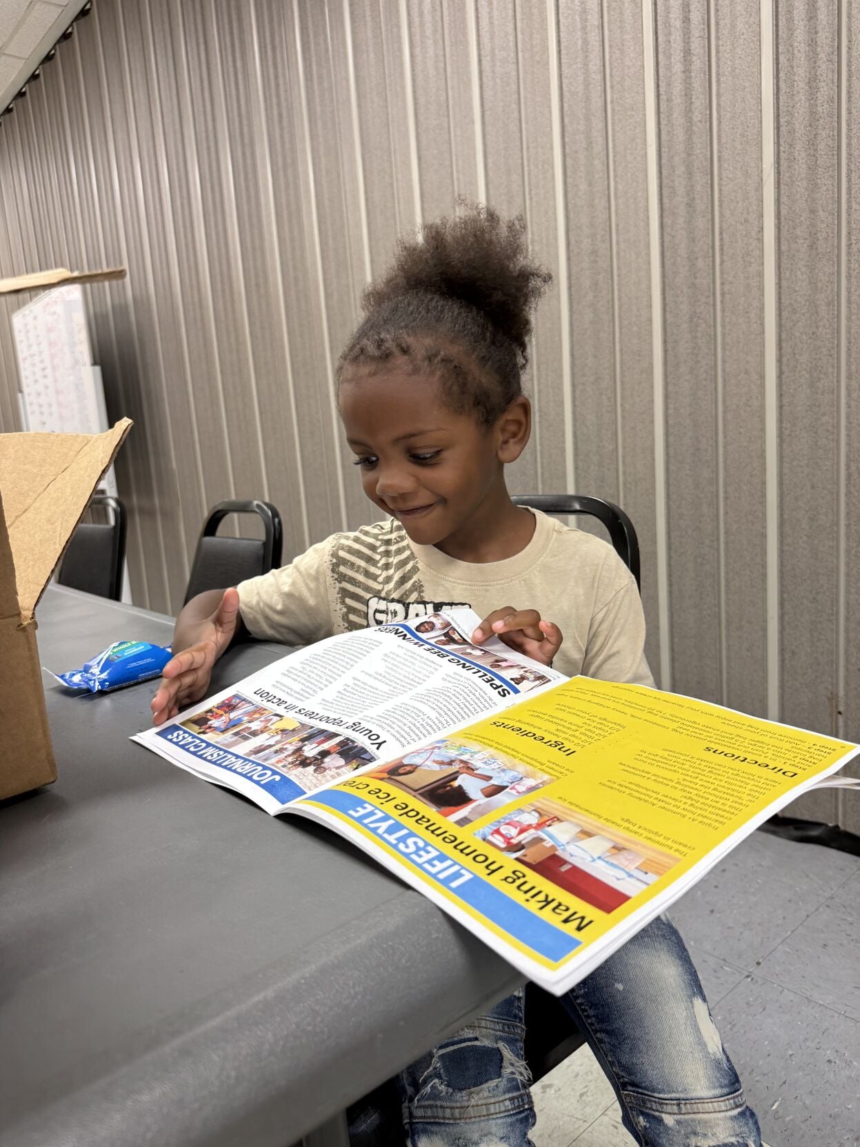 Sam reads the paper with smile