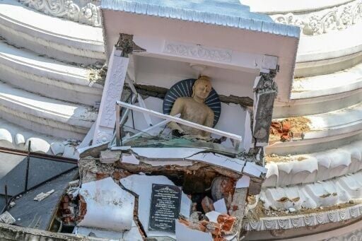 A statue of Buddha lies damaged following landslides in Gampola, in Kandy, on December 4, 2025