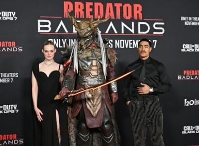 US actress Elle Fanning (L) and New Zealand actor Dimitrius Schuster-Koloamatangi star in 'Predator: Badlands'