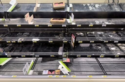 Shelves sit empty in the butcher section of a grocery store outside the US capital Washington