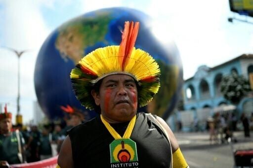 Under a baking sun, Indigenous people mixed with activists demonstrated in a festive atmosphere in Belem, Brazil
