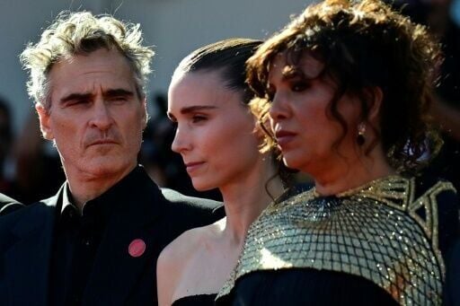 The powerful movie, by French-Tunisian director Kaouther Ben Hania (R), has garnered Hollywood backing from the likes of Joaquin Phoenix (L) and Rooney Mara (C)