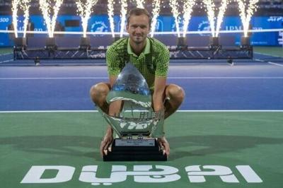 Russia's Daniil Medvedev poses with the trophy after winning the ATP title in Dubai