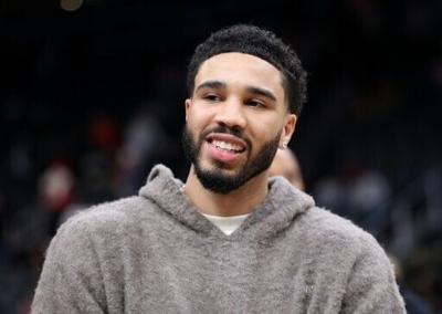 Injured Boston Celtics star Jayson Tatum reacts to the team's NBA win over the Atlanta Hawks