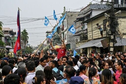 Supporters of the Rastriya Swatantra Party (RSP) celebrate outside the counting centre at Damak in Jhapa district