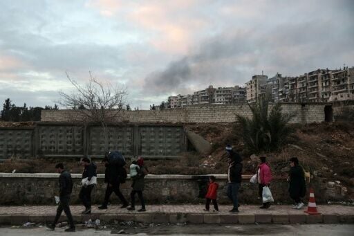 Residents carrying their belongings leave Aleppo's Kurdish-majority Sheikh Maqsud neighbourhood after days of deadly clashes