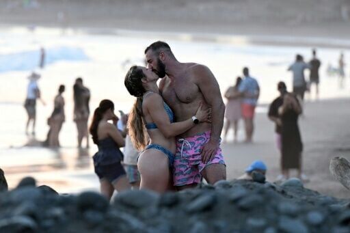 Tourists enjoy El Tunco beach, in La Libertad, El Salvador in February, amid picture-perfect waves and sunsets