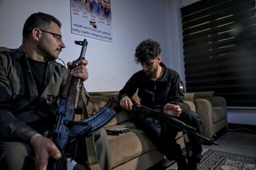 Aresto Pasbar (L), fled Iran in 2022 and ended up in Germany, but when the war started he headed to Iraq to join Iranian Kurdish rebels