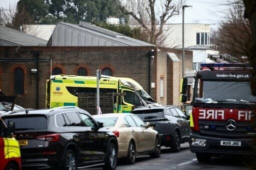 A damaged and burnt-out ambulance is pictured along a street in Golders Green, north London