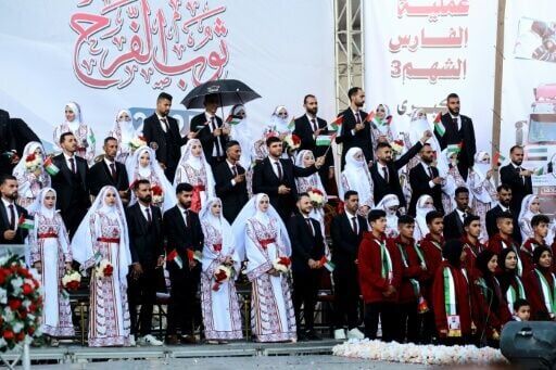Some 54 couples tied the knot in a mass wedding ceremony in Khan Yunis in southern Gaza -- a defiant celebration of life