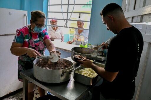 A Baptist pastor and assistants serve food to elderly worshippers at the Nazareth Baptist Church in Havana