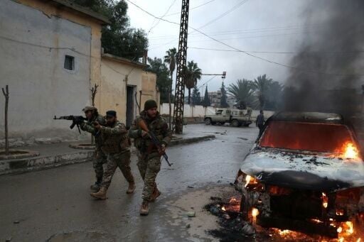 Kurdish-led forces and local fighters loyal to Damascus clashed in Raqa Sunday