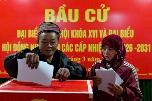 Ethnic minority citizens cast their votes inside a polling station in the northern Vietnamese province of Tuyen Quang