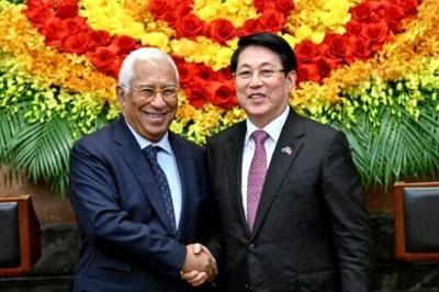 Vietnam's President Luong Cuong (R) shakes hands with European Council President Antonio Costa at the Presidential Palace in Hanoi