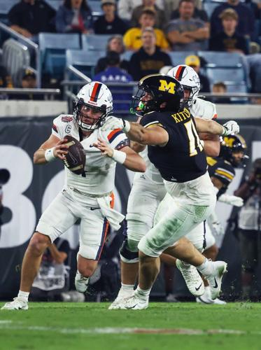 Mizzou defensive end Langden Kitchen (11) moves to tackle Virginia quarterback Chandler Morris (4)