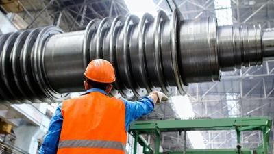 Factory Worker Directing Heavy Machinery