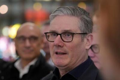 Britain's Prime Minister Keir Starmer spoke to reporters aboard a plane bound for China, where he arrived for an official visit