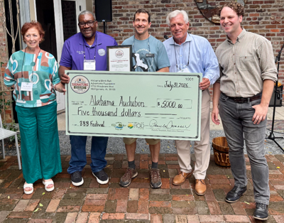 Pam Swanner presents check to Alabama Audubon