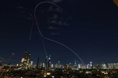 Rocket trails from an interception by Israel's Iron Dome missile defence system over Tel Aviv on March 1