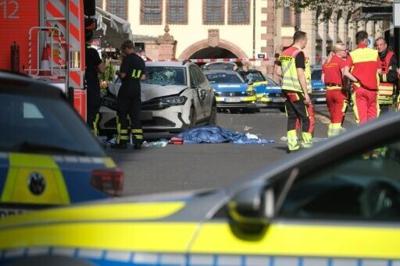 Members of the emergency services work at the scene where several people were injured during an incident involving a car in the city centre in Leipzig, eastern Germany
