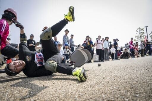 A racer falls during the qualifiers for the ISU-1 Grand Prix in Kyotanabe, Japan