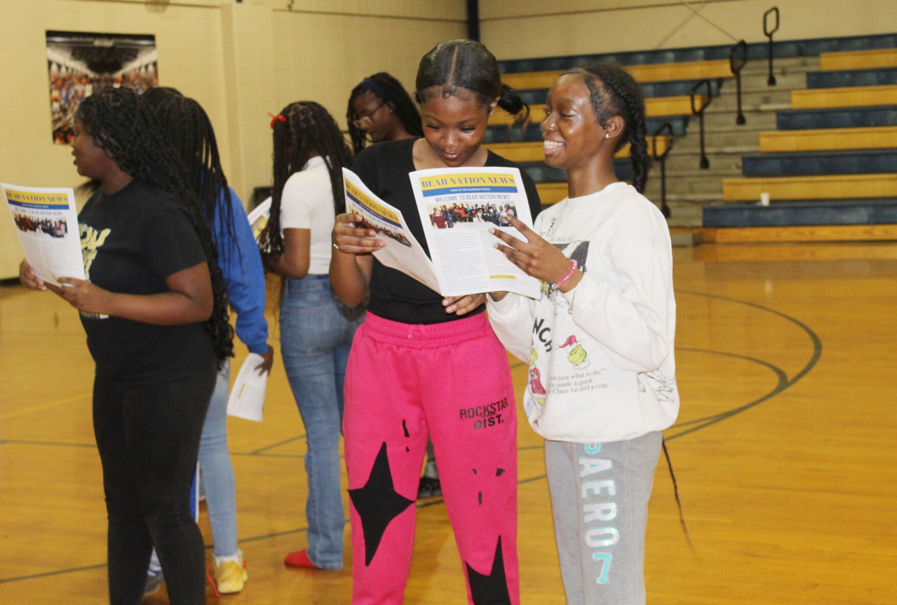Smiling with papers at Keith High
