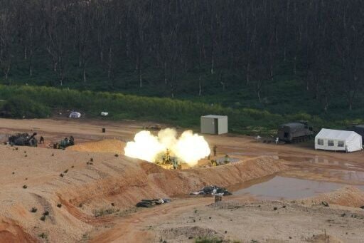 An Israeli self-propelled howitzer fires rounds towards southern Lebanon from a position in northern Israel near the border