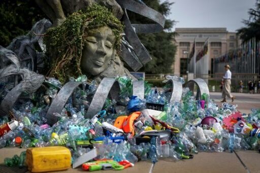 A 'Thinker' drowns in plastic garbage as UN treaty talks open