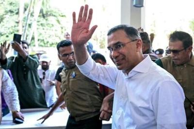 Bangladesh Nationalist Party (BNP) chairman Tarique Rahman (R) after addressing a press conference in Dhaka on February 14, 2026