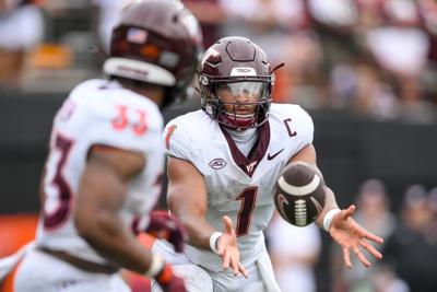 Virginia Tech QB Kyron Drones, backup staying with Hokies