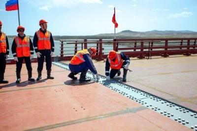 This handout image released by the Russian Transport Ministry shows a ceremony marking the connection of the two sides of the new Russia-North Korea road bridge