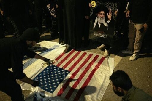 Iraqis prepare to burn US flags at a rally in support of the Palestinian people