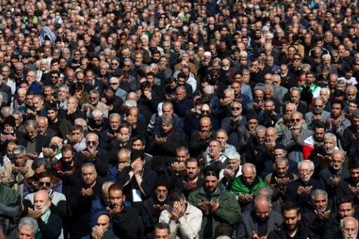 Muslims take part in Friday noon prayers at the compound of the Mosalla mosque in Tehran